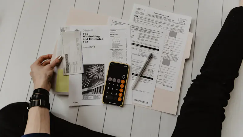 Financial paperwork and a calculator on a desk.